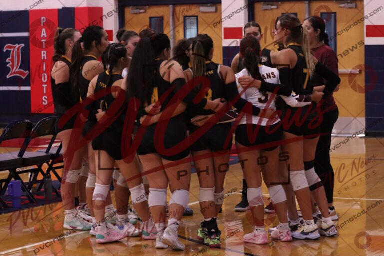 Trojans Battle Liberty in Competitive Three-Set Match